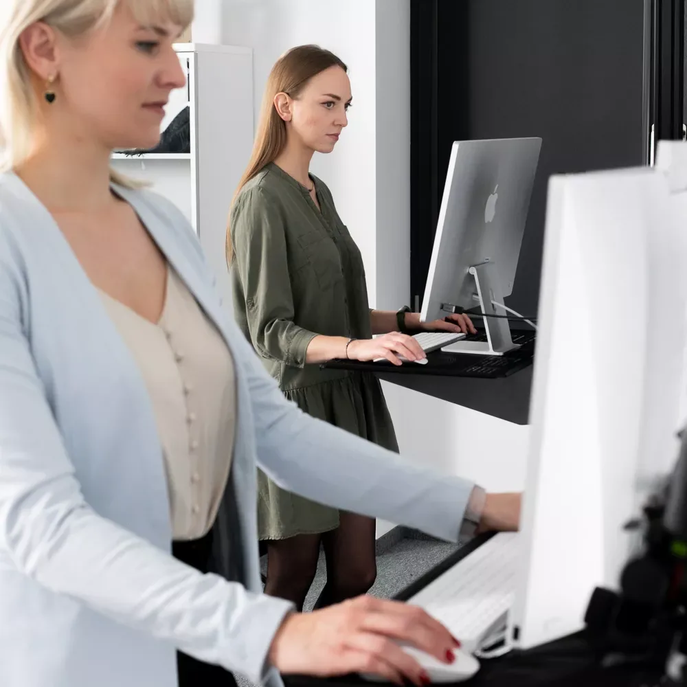 Two women working at computers in an Orbitvu photography studio