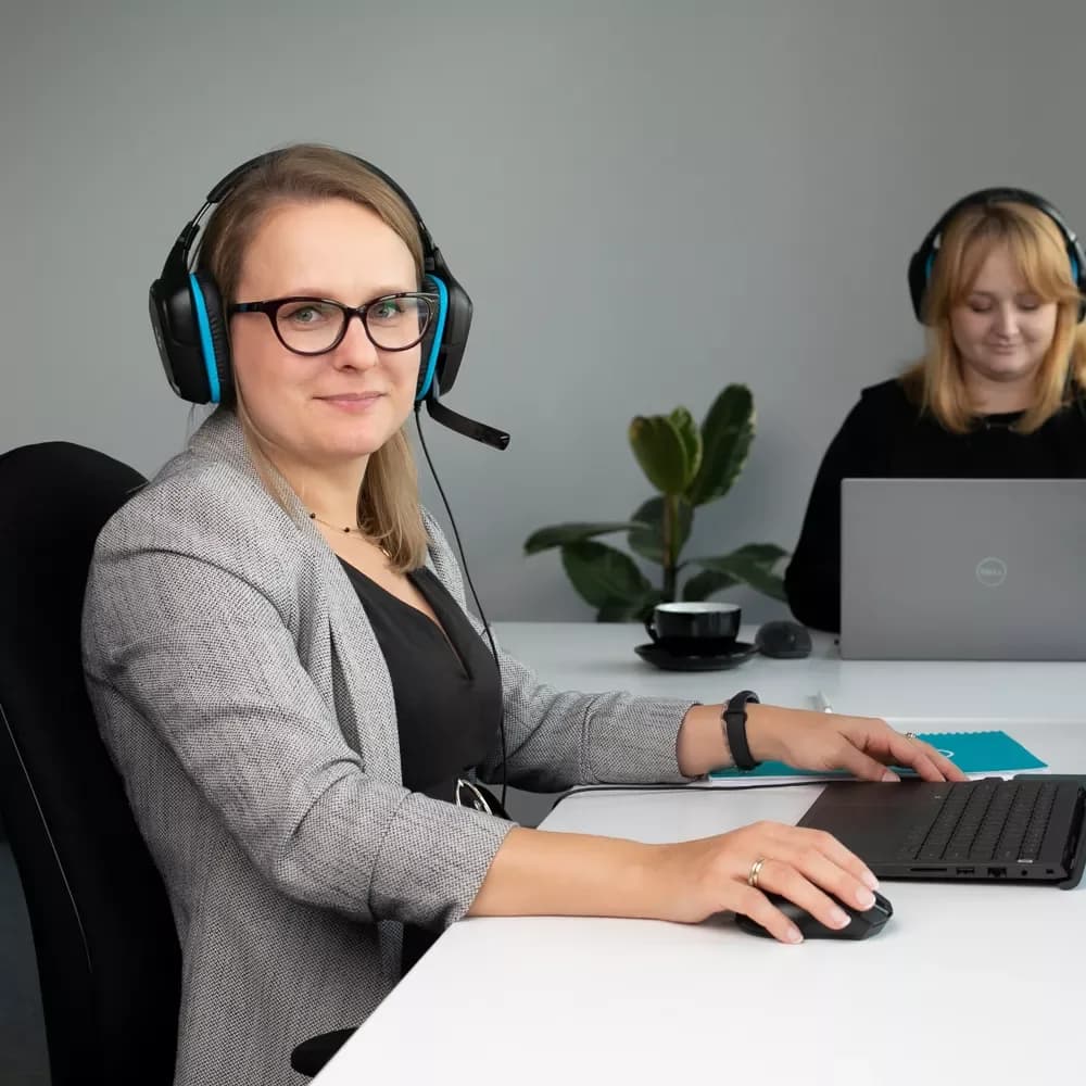 Two women wearing headsets in the Orbitvu customer support office